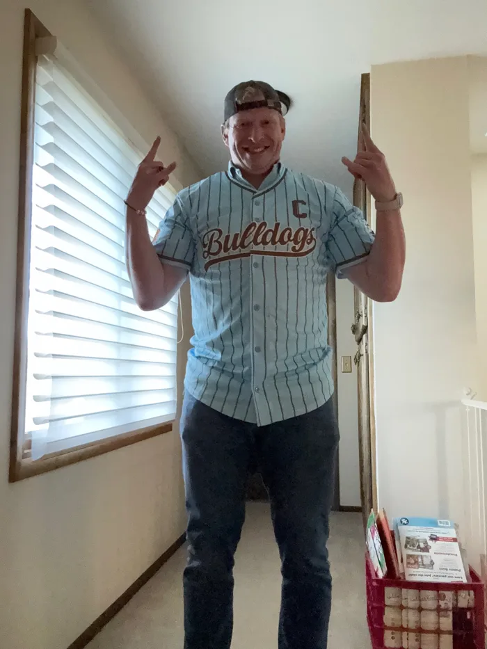 Matt Kramer in a Bulldogs jersey, both hands up